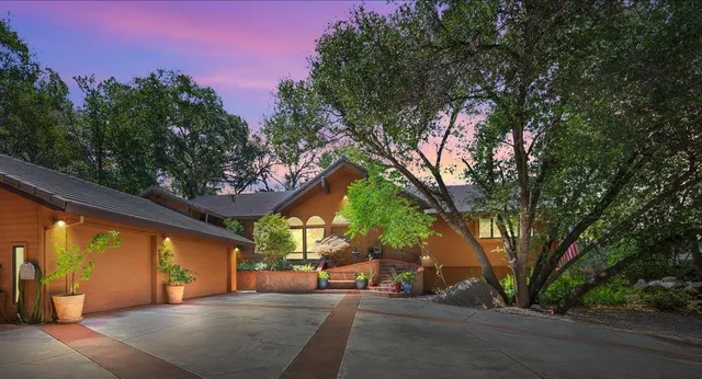 a living room with fireplace furniture and a large window
