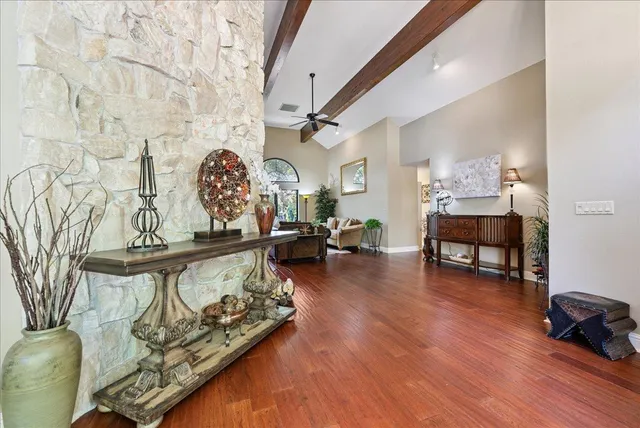 a bathroom with a granite countertop sink mirror vanity and toilet