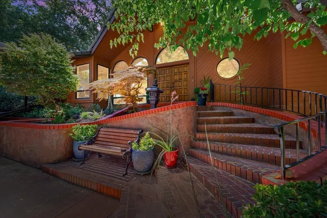 a living room with fireplace furniture and a large window
