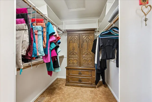 a view of a patio with table and chairs and floor to ceiling window