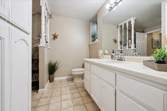 an aerial view of residential house with outdoor space and trees all around