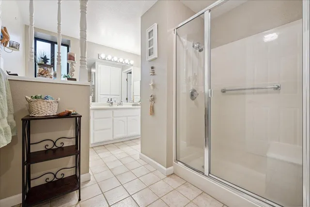 an aerial view of residential house with outdoor space and trees all around