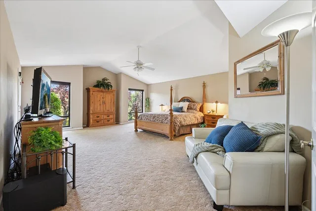 a dining room with furniture a chandelier and wooden floor
