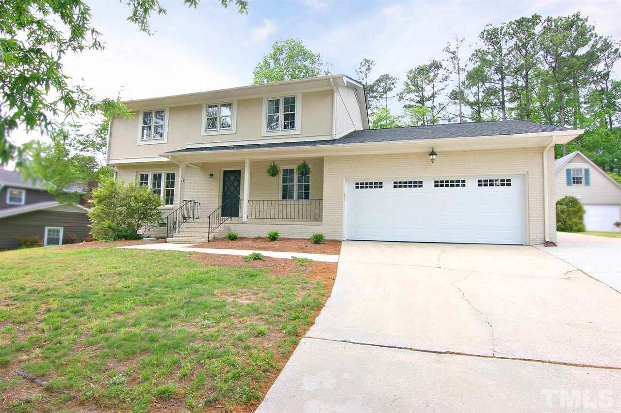 7801 Audubon Drive Raleigh, NC 27615 - Photo 1 of 25 a front view of house with yard and trees in the background