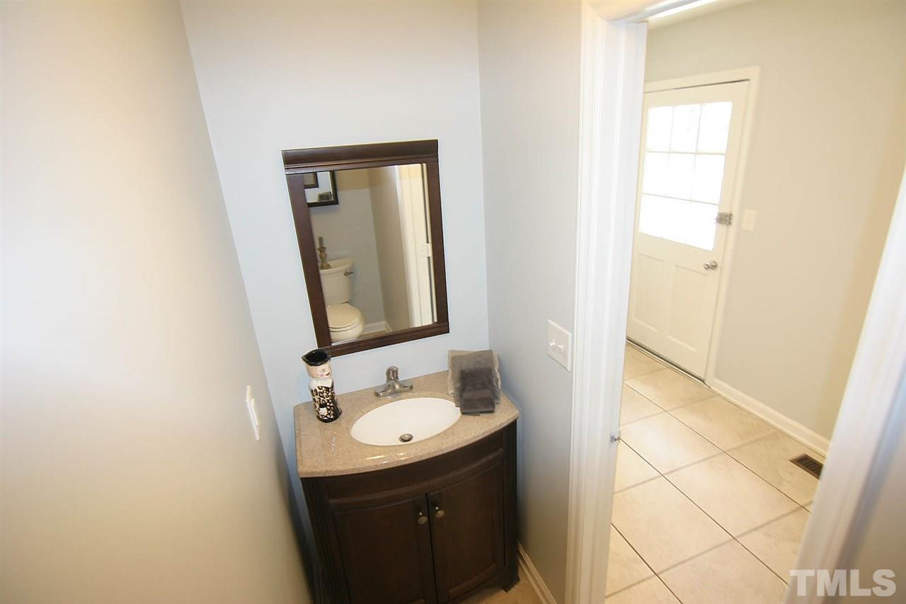 7801 Audubon Drive Raleigh, NC 27615 - Photo 13 of 25 a bathroom with a sink and a mirror