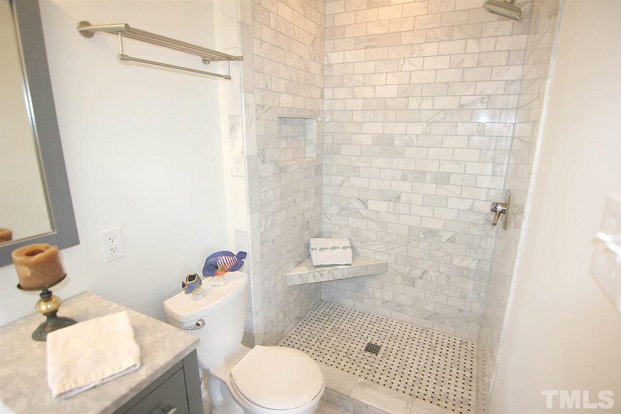 7801 Audubon Drive Raleigh, NC 27615 - Photo 17 of 25 a bathroom with a sink toilet and shower