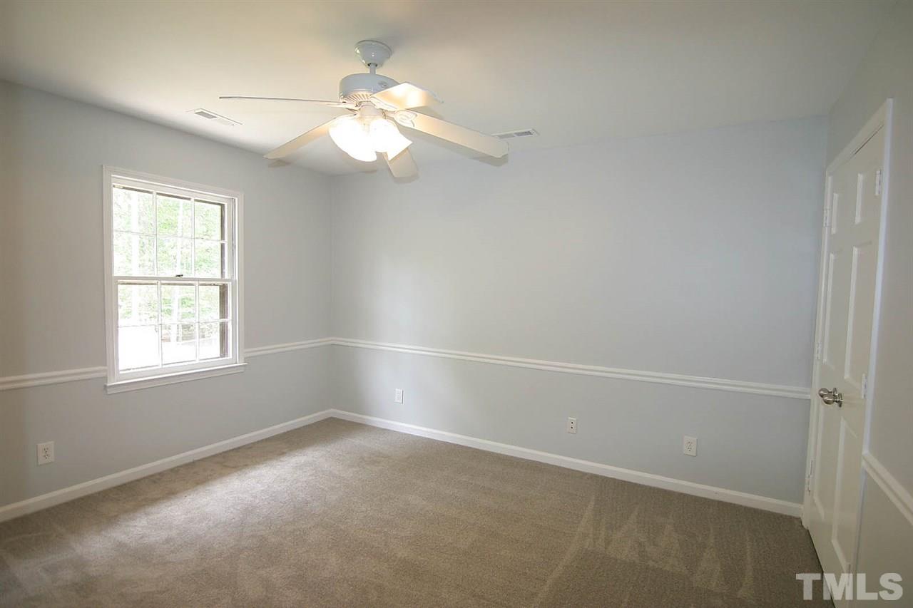 7801 Audubon Drive Raleigh, NC 27615 - Photo 22 of 25 an empty room with windows and fan