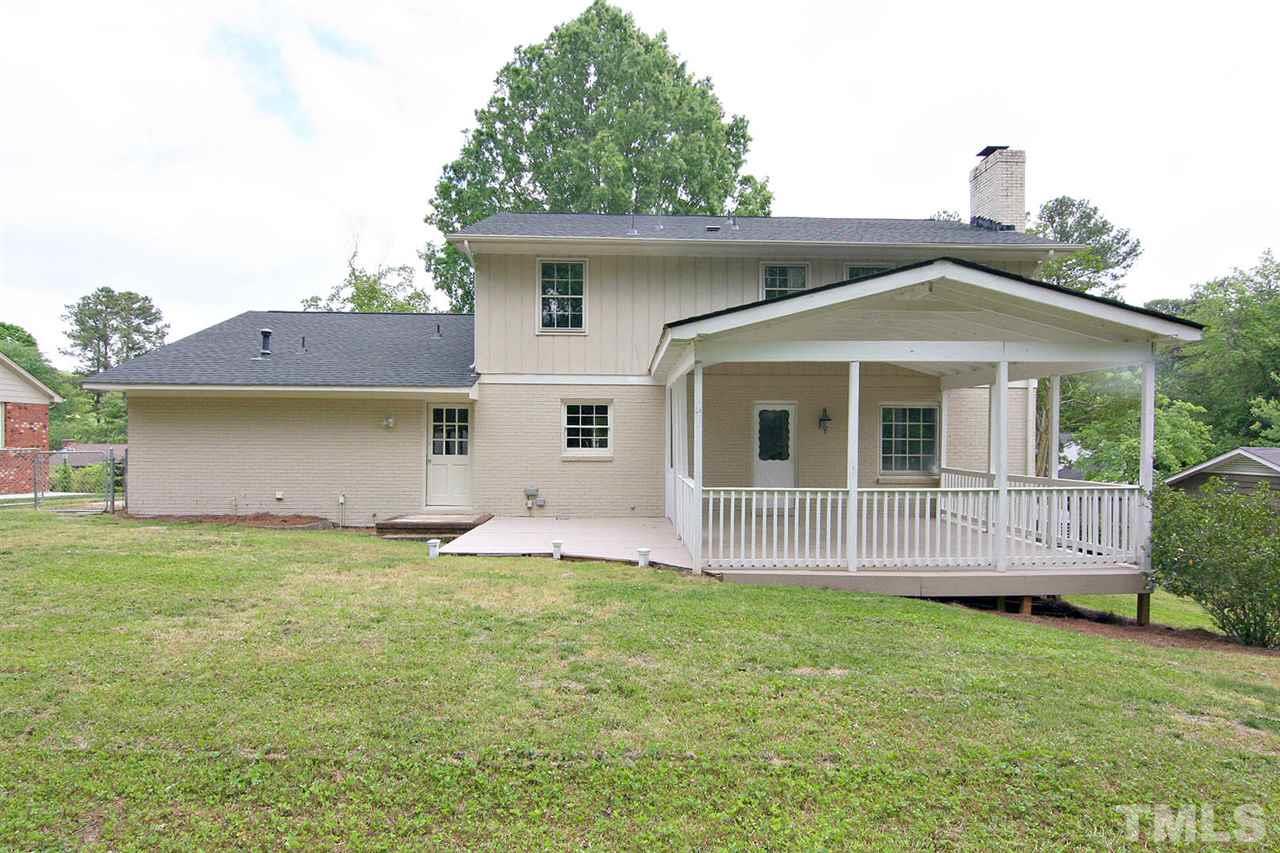 7801 Audubon Drive Raleigh, NC 27615 - Photo 23 of 25 a front view of a house with a garden and yard
