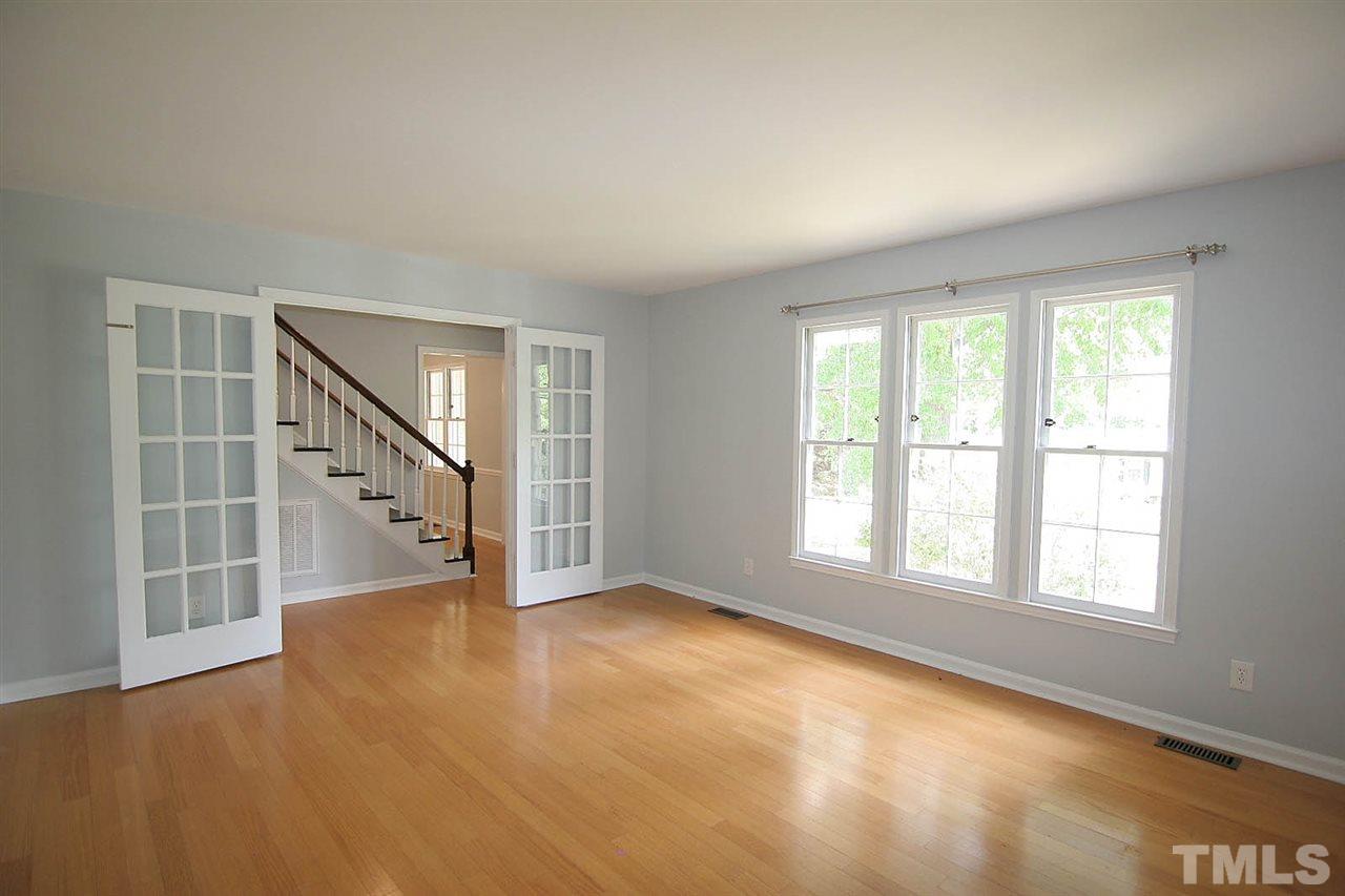 7801 Audubon Drive Raleigh, NC 27615 - Photo 5 of 25 an empty room with windows and entrance