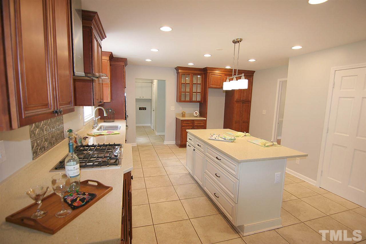 7801 Audubon Drive Raleigh, NC 27615 - Photo 10 of 25 a large white kitchen with a large window