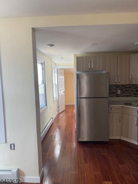 863 Lafayette Street Elizabeth, NJ 07201 - Photo 16 of 20 a kitchen with a refrigerator and a stove top oven