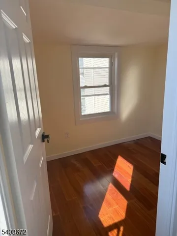 a view of an empty room and wooden floor