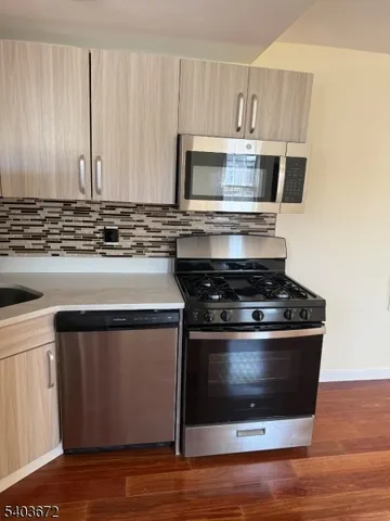 a stove top oven sitting inside of a kitchen