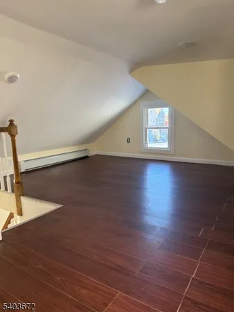 a view of a room with wooden floor