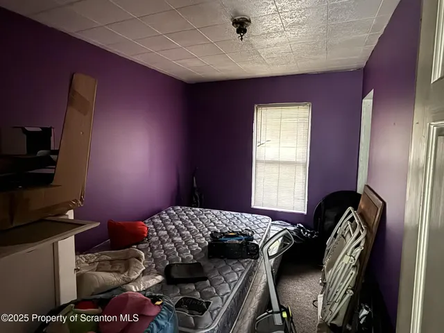 a bedroom with a bed and dresser