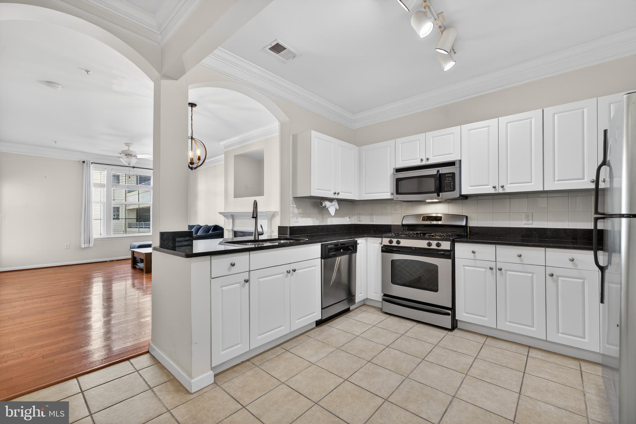 31 Booth Street, Unit 358 Gaithersburg, MD 20878 - Photo 2 of 20 a kitchen with white cabinets appliances and a window