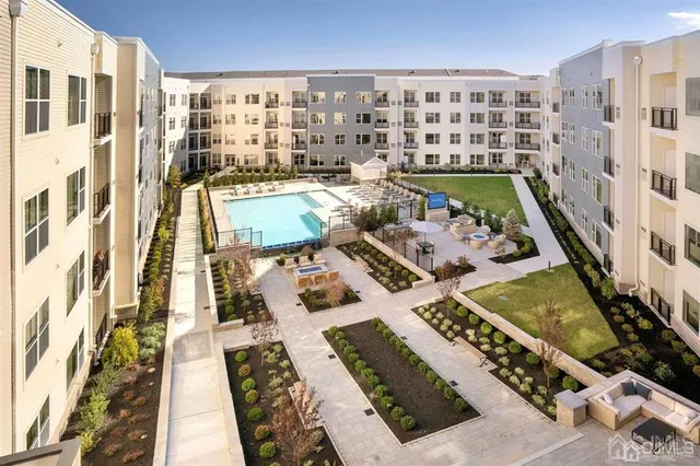 a view of a patio with couches and table and chairs and potted plants