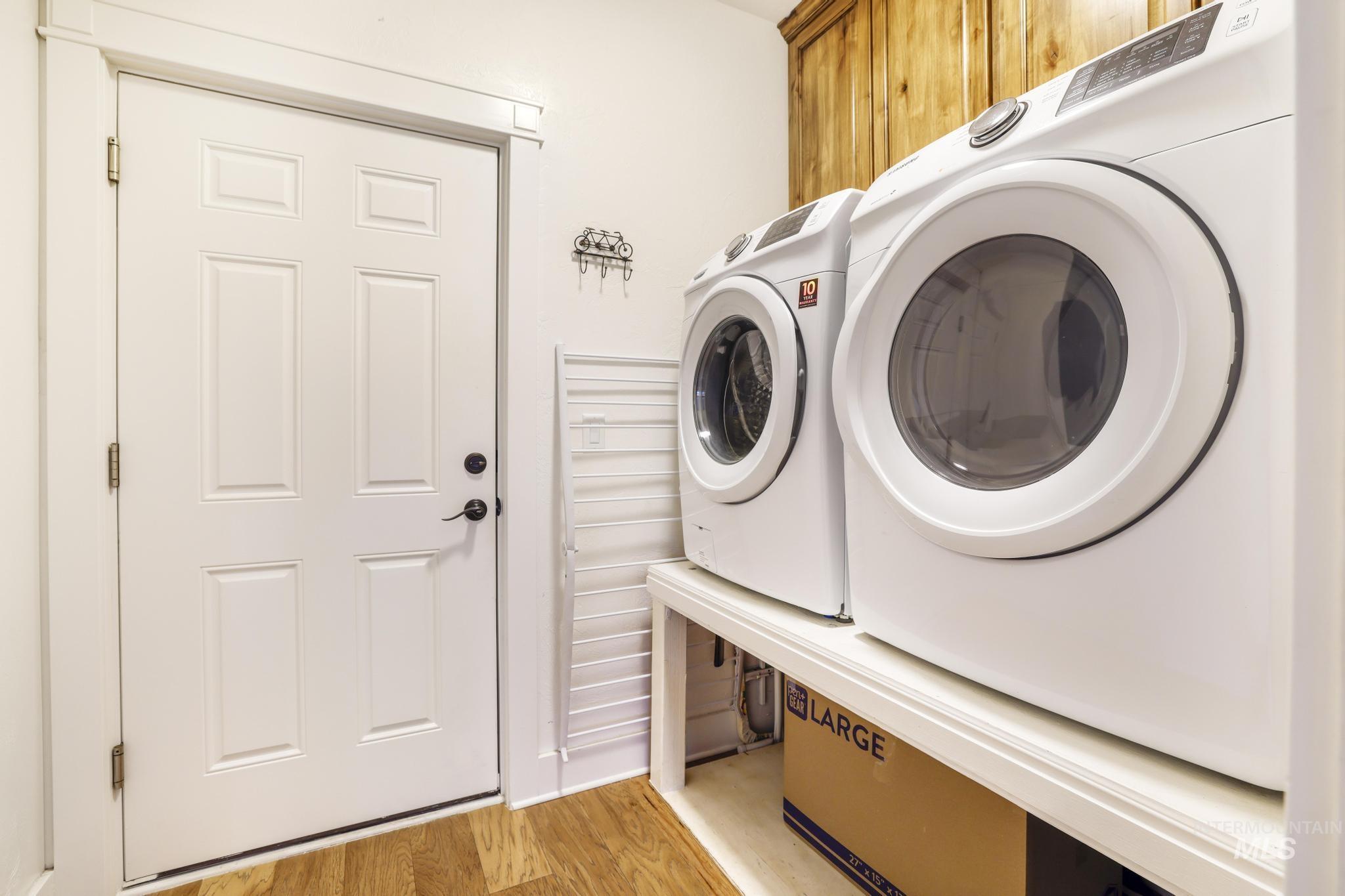 2157 Cayuse Street Twin Falls, ID 83301 - Photo 35 of 48 Laundry area with light wood-type flooring, cabinet space, and washer and clothes dryer