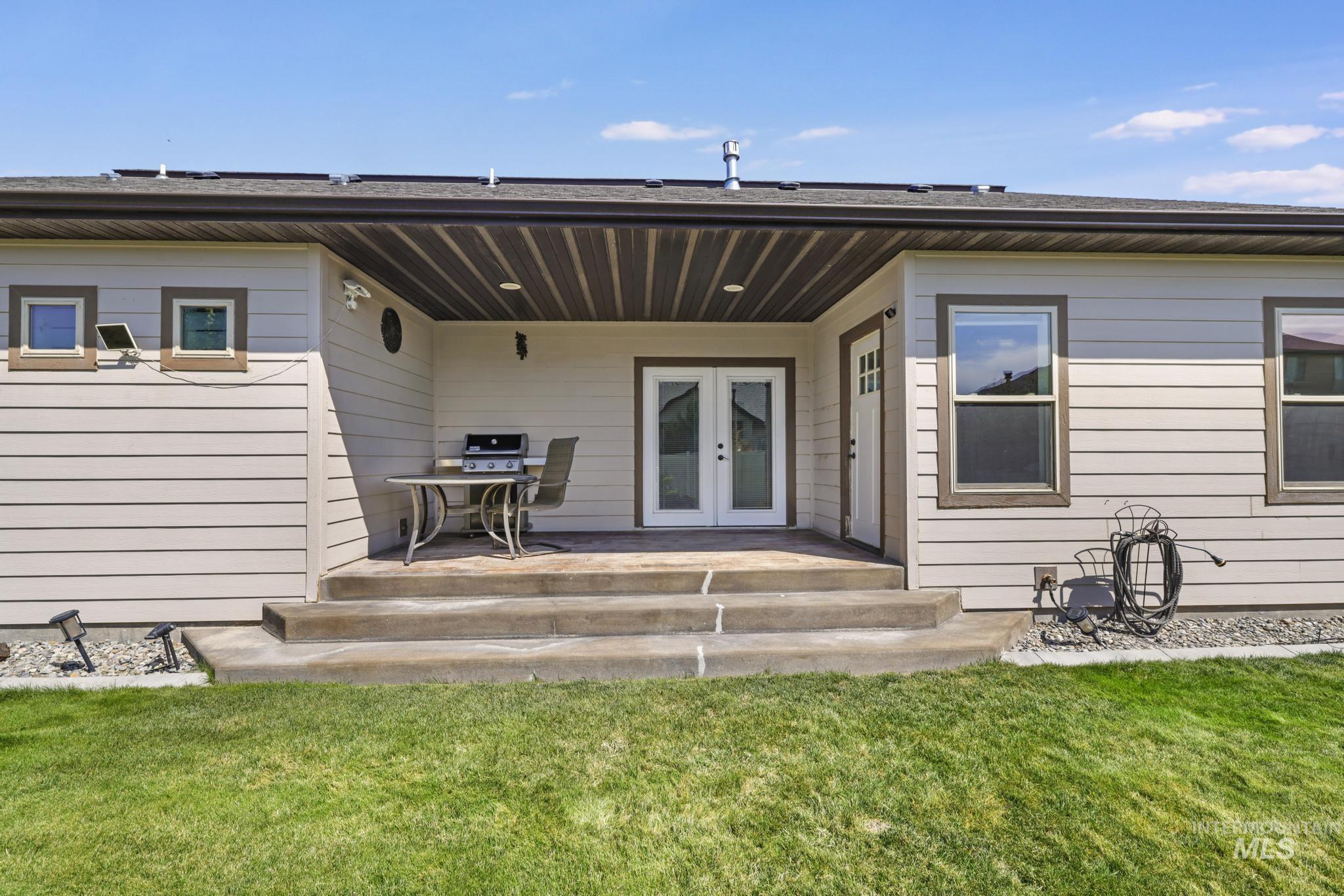 2157 Cayuse Street Twin Falls, ID 83301 - Photo 38 of 48 Back of house featuring french doors, a patio area, and a yard