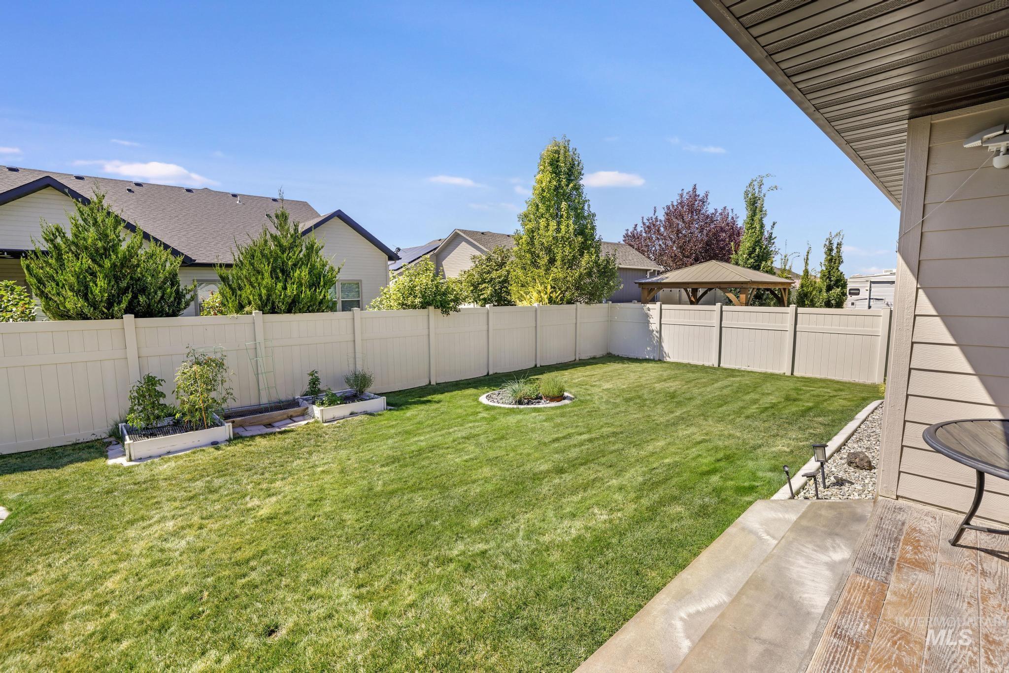 2157 Cayuse Street Twin Falls, ID 83301 - Photo 39 of 48 Fenced backyard featuring a patio area and a vegetable garden