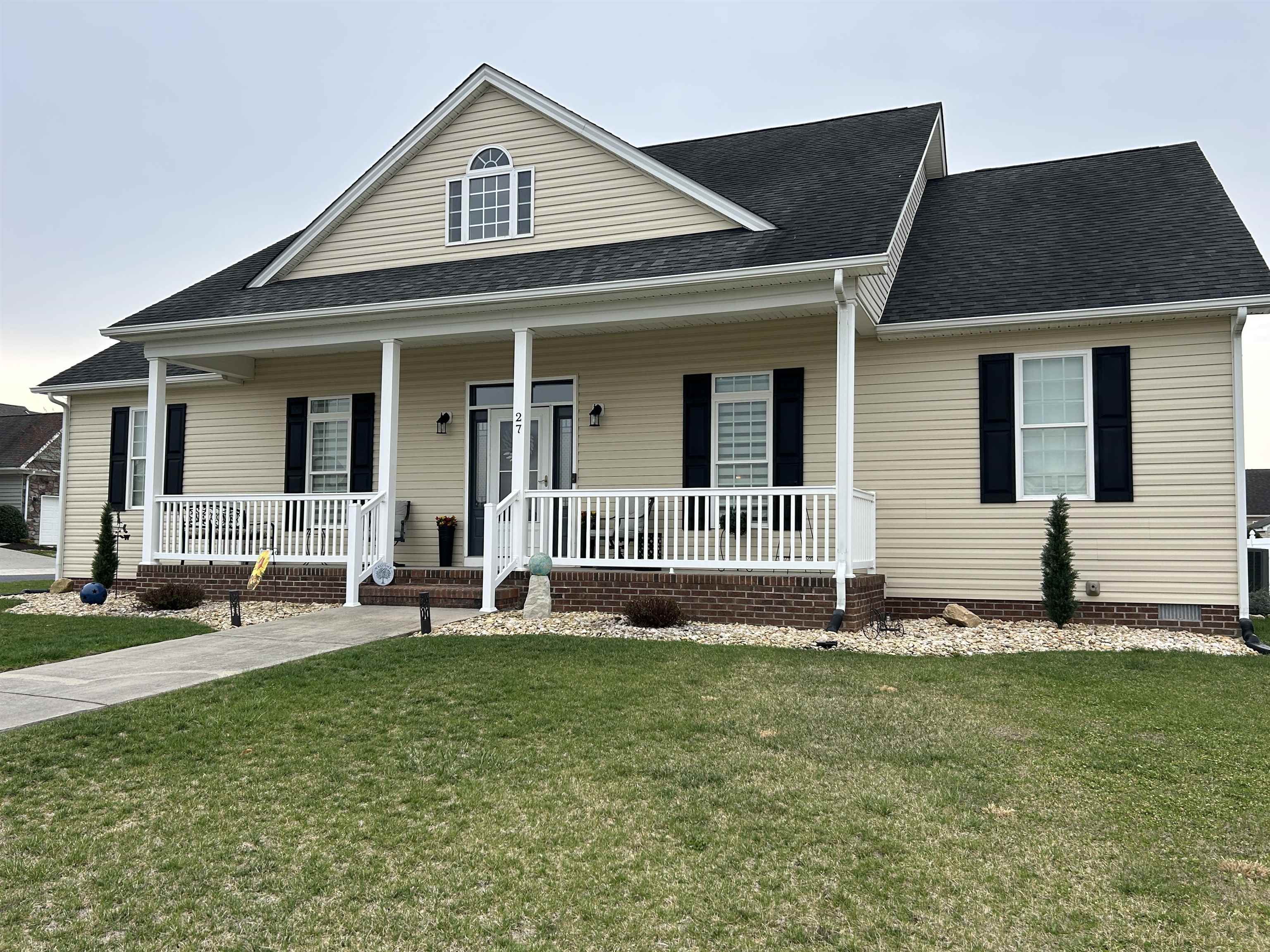 a front view of a house with a yard and table