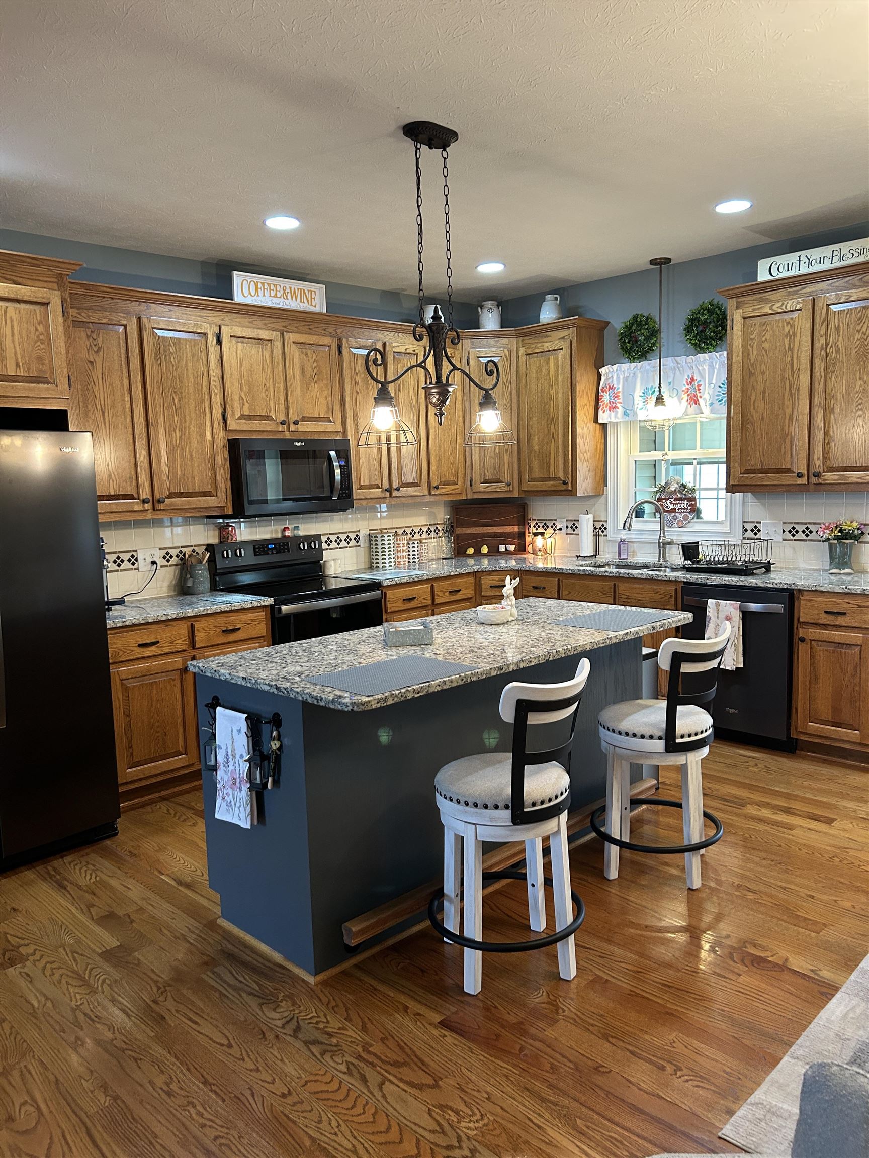 27 Slate Drive Stuarts Draft, VA 24477 - Photo 8 of 40 a kitchen with kitchen island granite countertop a sink cabinets and wooden floor