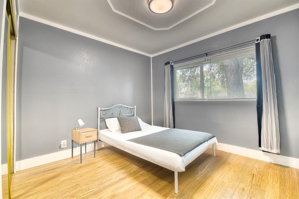 3214 Parker Street Irving, TX 75062 - Photo 17 of 22 a bedroom with a bed and a window