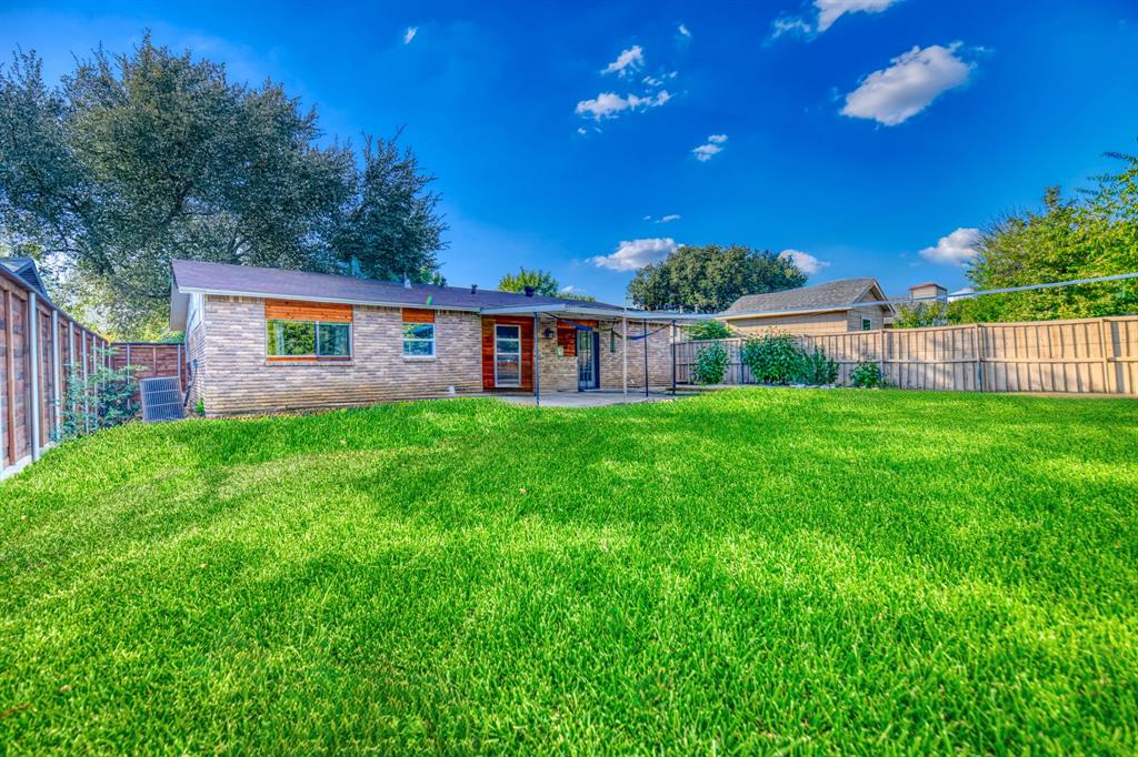 3214 Parker Street Irving, TX 75062 - Photo 19 of 22 a view of a house with a big yard potted plants and large tree