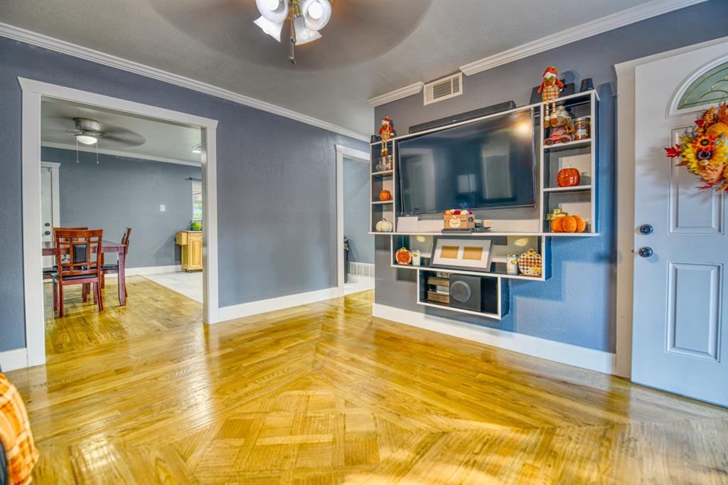 3214 Parker Street Irving, TX 75062 - Photo 5 of 22 a living room with stainless steel appliances kitchen island granite countertop furniture and a flat screen tv