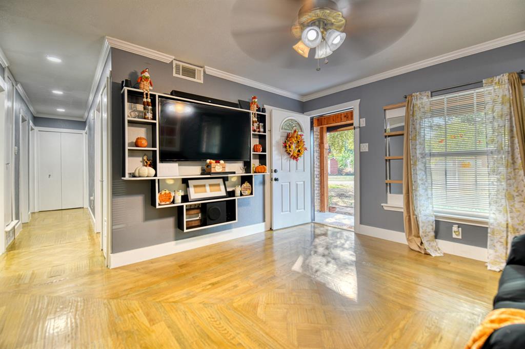 3214 Parker Street Irving, TX 75062 - Photo 6 of 22 a living room with stainless steel appliances furniture and a flat screen tv