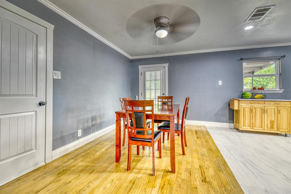 3214 Parker Street Irving, TX 75062 - Photo 7 of 22 a view of a dining room with furniture and wooden floor