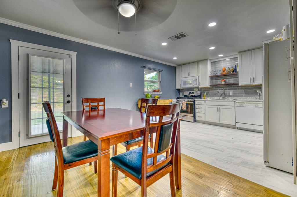 3214 Parker Street Irving, TX 75062 - Photo 9 of 22 a view of a dining room with furniture and wooden floor