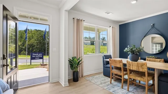a view of a dining room with a table and chairs