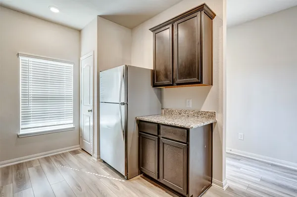 a kitchen with stainless steel appliances granite countertop a refrigerator and a stove