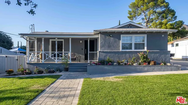 a front view of a house with swimming pool and porch