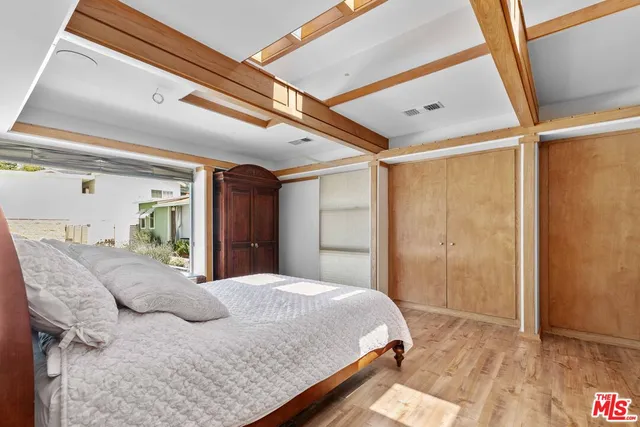 a bedroom with a large bed and a large window