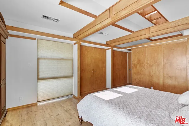 a bedroom with a bed and a mirror