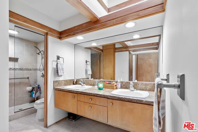 a bathroom with a double vanity sink and a mirror
