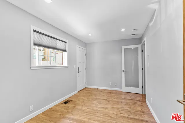 a view of empty room with wooden floor