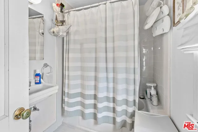 a bathroom with a shower and a sink