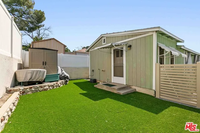 a backyard of a house with table and chairs