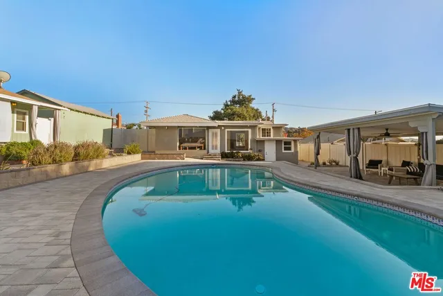 a view of a house with swimming pool and porch