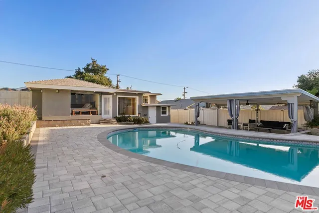 a view of a house with swimming pool and sitting area