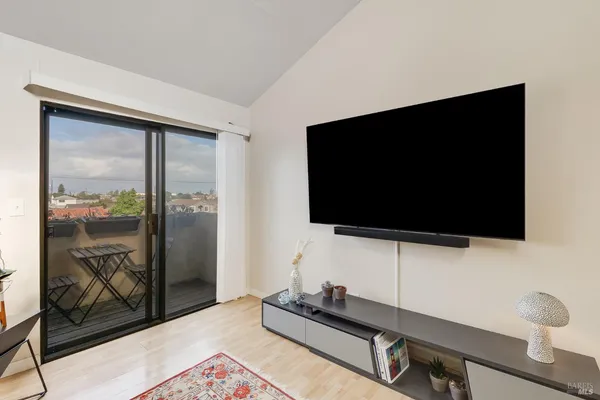 a living room with a flat screen tv and a floor to ceiling window