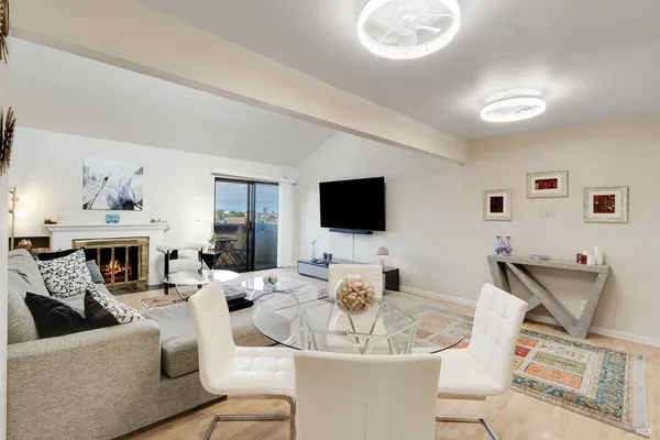 a living room with furniture a flat screen tv and a fireplace