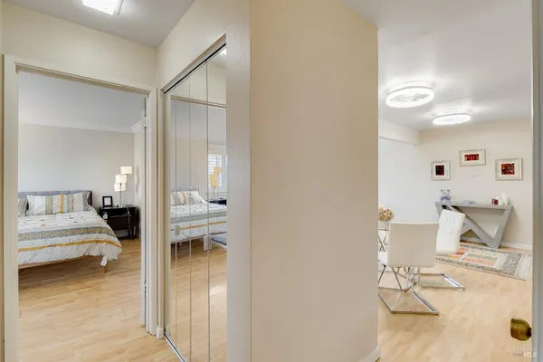 a bedroom with a bed and a view of living room