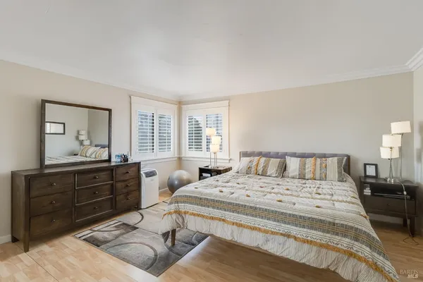 a large bedroom with a large bed and a window