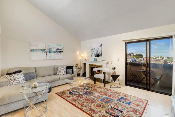 a living room with furniture and a rug