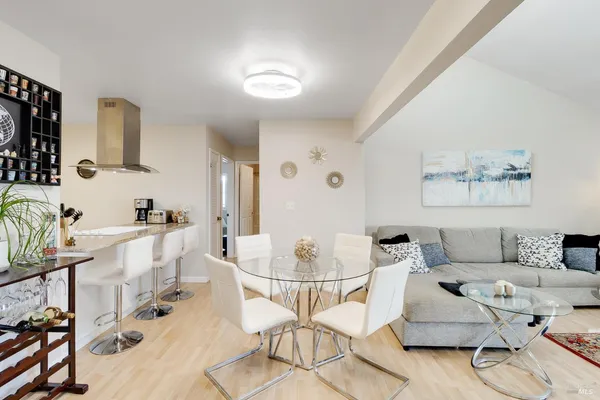 a living room with furniture and a dining table