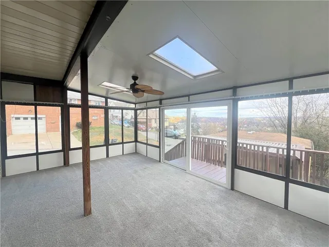 a view of an empty room with windows